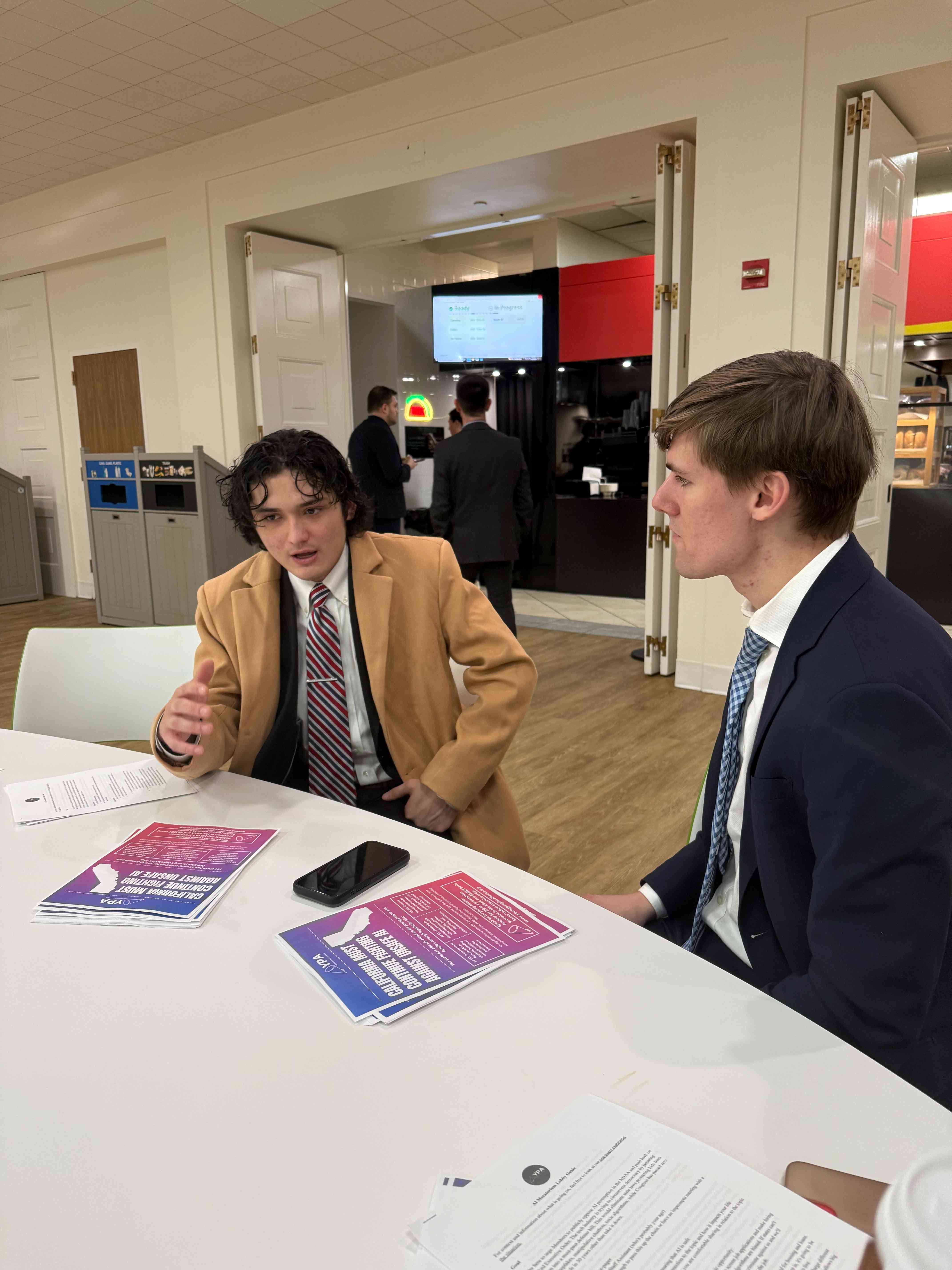 YPA members discussing AI policy with legislative materials