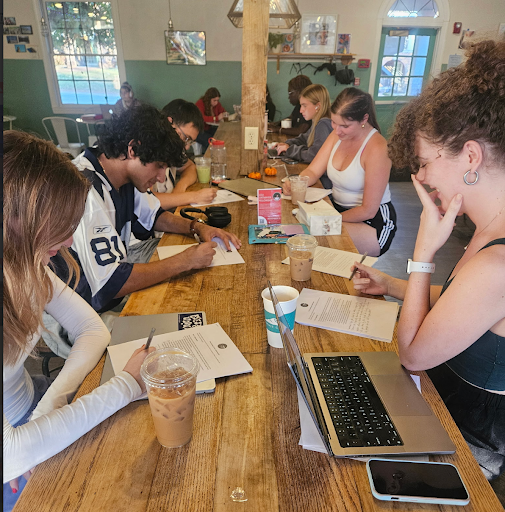 Student holding VOTE sign at voter registration event