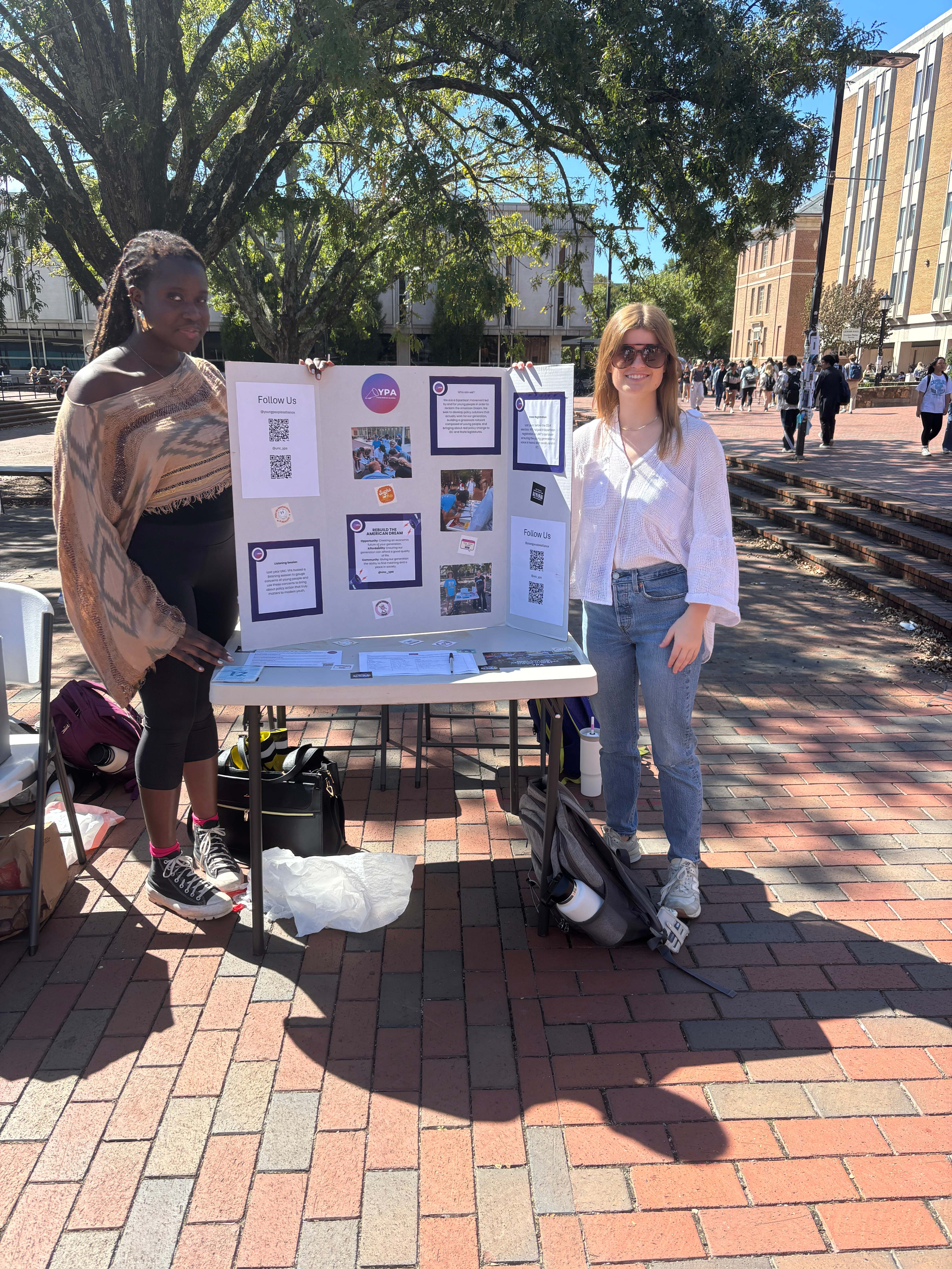 YPA members tabling on campus with information display board